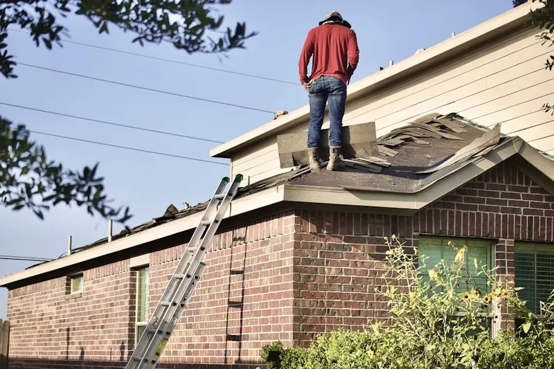 Professional roofer working on a residential roof in Beresford